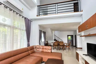 Spacious modern living room with high ceilings and elegant furniture in a stylish home.