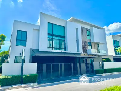 Modern luxury townhouse with sleek design and large windows in a serene neighborhood.