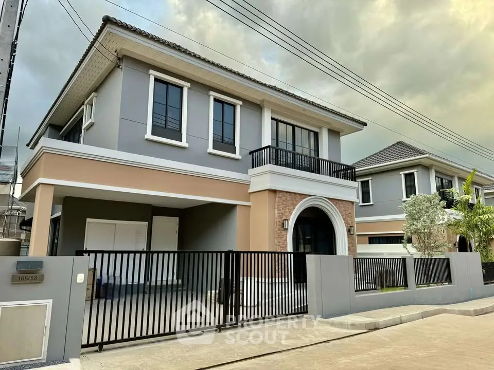 Elegant two-story house with modern design and gated entrance in a serene neighborhood.