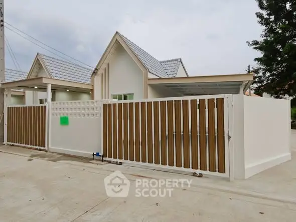 Charming single-story home with modern fence and spacious driveway in a serene neighborhood.