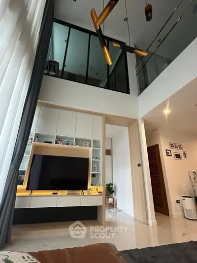 Modern living room with high ceiling and stylish lighting in a contemporary home