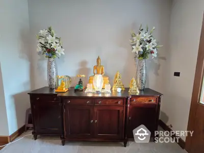 Elegant interior with wooden cabinet and decorative Buddha statues