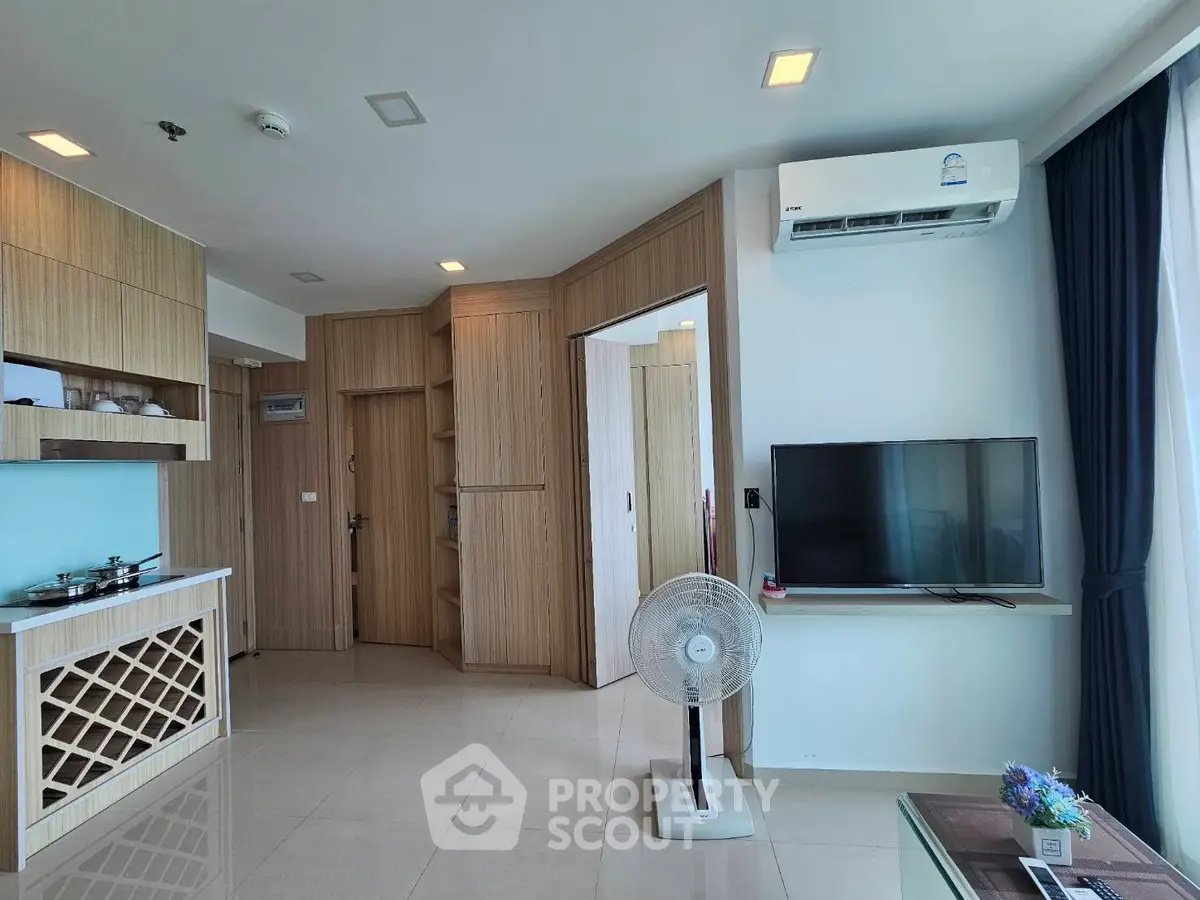 Modern living room with built-in wooden cabinets and air conditioning