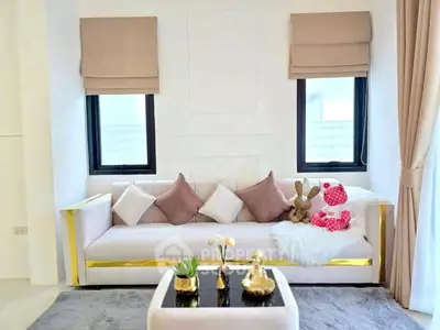 Elegant living room with plush sofa, decorative pillows, and chic decor accents.