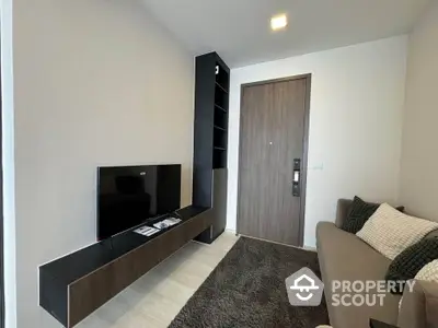 Modern living room with sleek TV unit and cozy sofa in stylish apartment