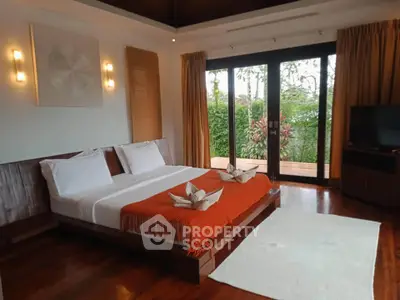Luxurious bedroom with elegant decor and garden view, featuring a cozy bed and stylish lighting.