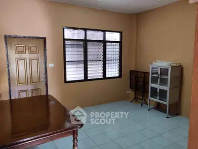 Cozy study room with wooden table and storage cabinet, perfect for productivity.
