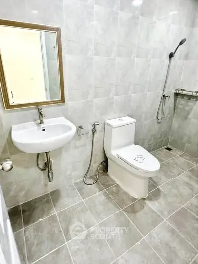 Modern bathroom with sleek fixtures and tiled walls in a contemporary home.