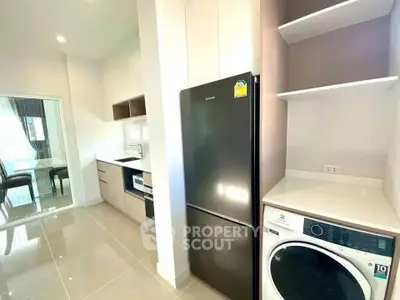 Modern kitchen with sleek appliances and open layout in a stylish apartment.