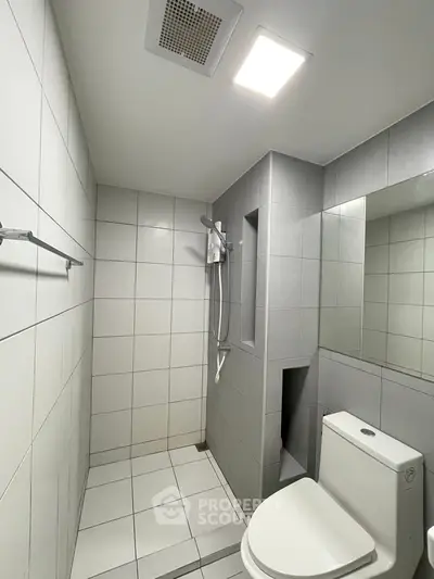 Modern minimalist bathroom with sleek tiles and shower area