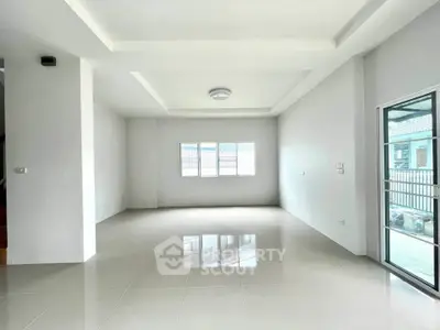 Spacious modern living room with large windows and glossy tiled floors in a bright, open layout.