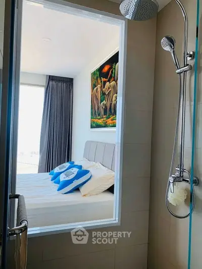 Modern bathroom with a view into a stylish bedroom featuring elegant decor and natural light.