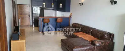 Modern living room with leather sofa and stylish kitchen bar
