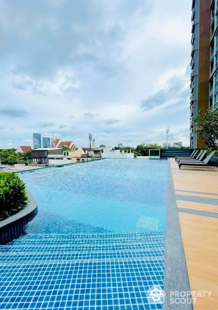 Luxurious rooftop pool with stunning city views in modern high-rise building.