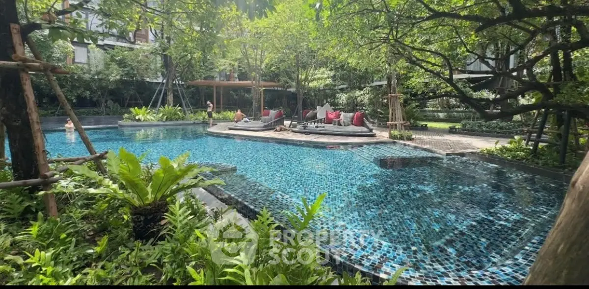 Luxurious residential pool surrounded by lush greenery and modern design.