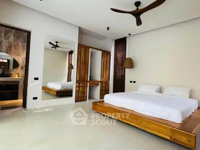 Spacious modern bedroom with wooden accents and ensuite bathroom