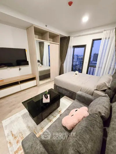 Modern studio apartment with cozy living area and city view