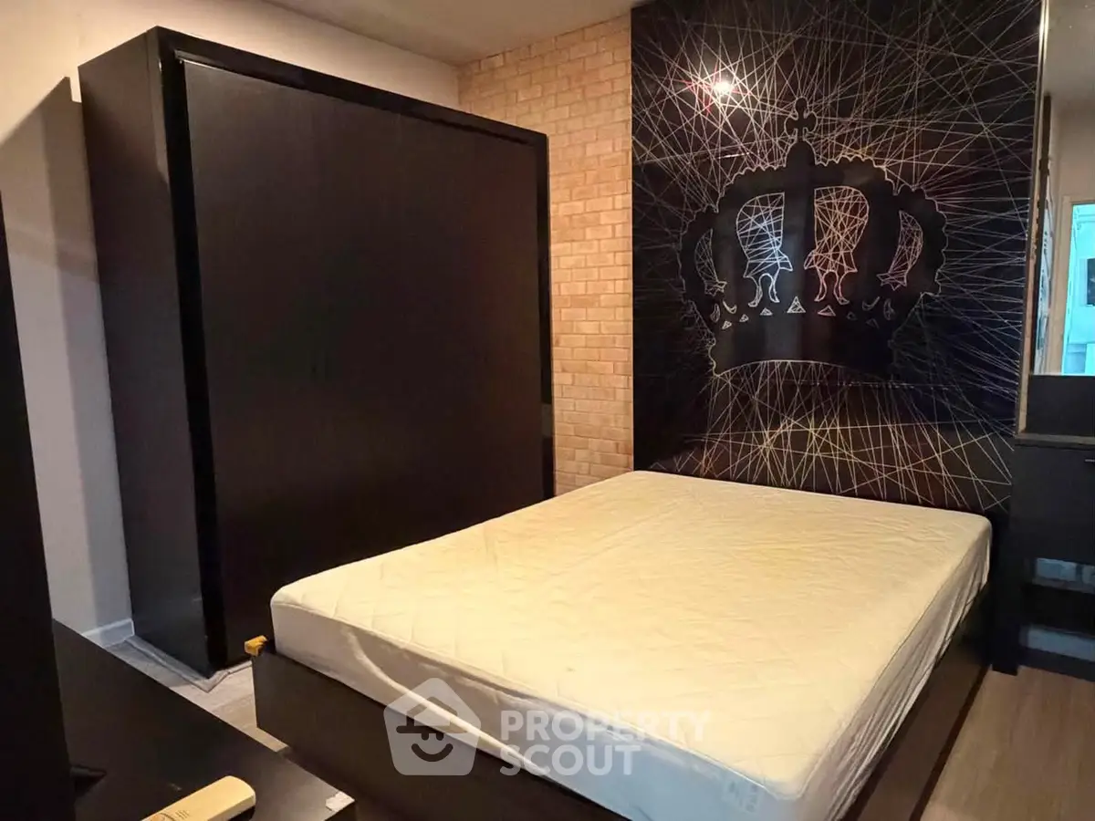 Modern bedroom with stylish crown wall art and sleek dark furniture