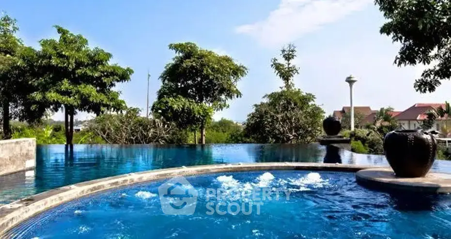 Luxurious infinity pool with serene surroundings and lush greenery