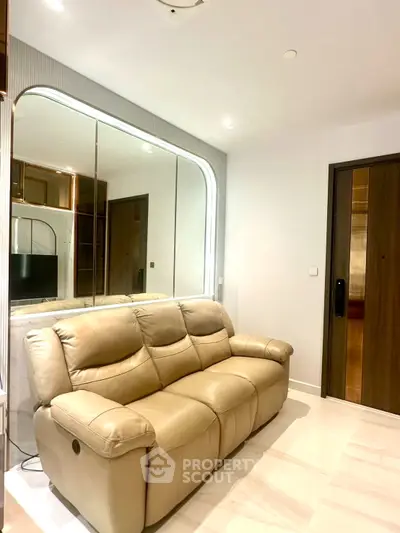Modern living room with beige leather sofa and elegant mirrored wall