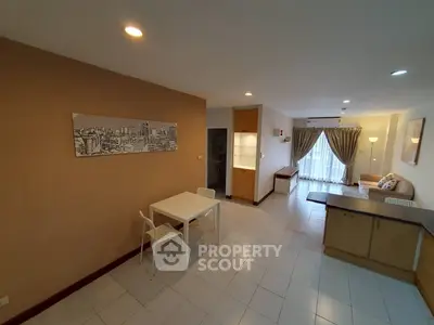 Spacious open-plan living room with modern decor and ample natural light.