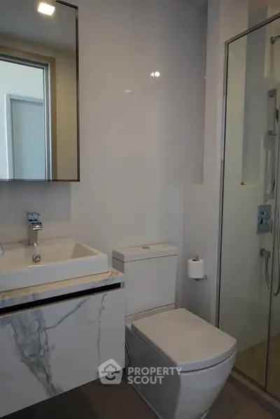 Modern bathroom with sleek fixtures and glass shower enclosure