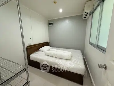 Cozy minimalist bedroom with air conditioning and modern shelving