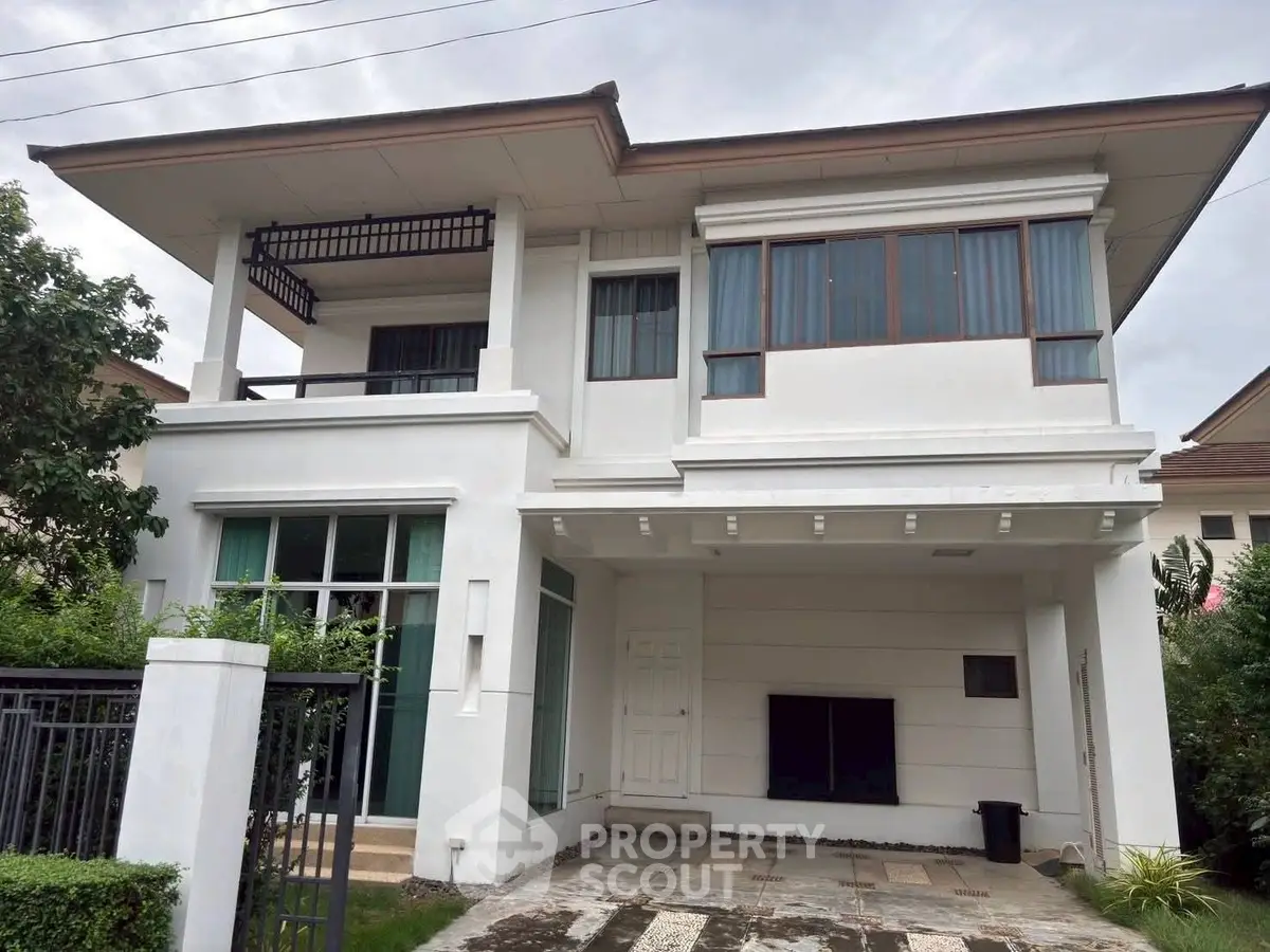 Elegant two-story white house with modern design and lush greenery, perfect for family living.