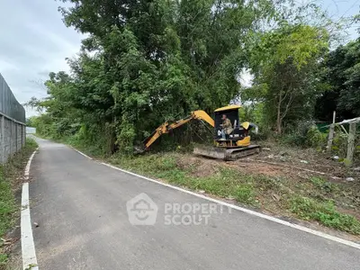 Vacant land with excavator clearing trees for development