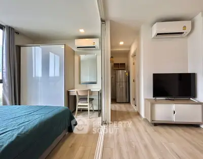 Modern studio apartment with sleek design, featuring a cozy bedroom, compact kitchen, and stylish living area.