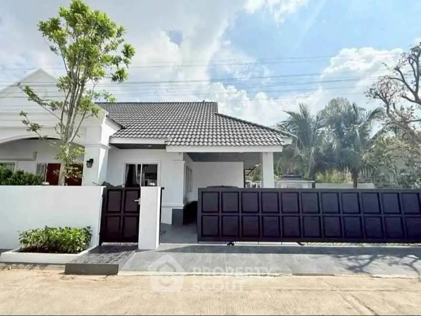 Charming single-story house with modern design and spacious front yard, perfect for family living.