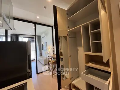 Modern apartment kitchen with open cabinets and sleek dining area