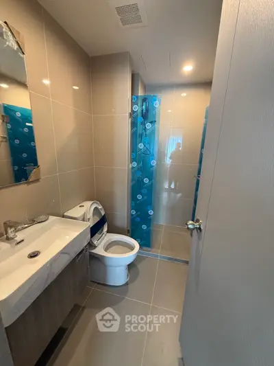 Modern bathroom with sleek fixtures and spacious shower area