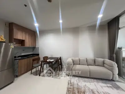 Modern open-layout living room with cozy sofa and compact dining area in stylish apartment.