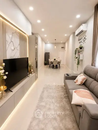 Modern living room with sleek design, cozy seating, and elegant lighting, perfect for relaxation and entertainment.
