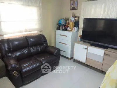 Cozy living room with leather sofa and modern TV setup