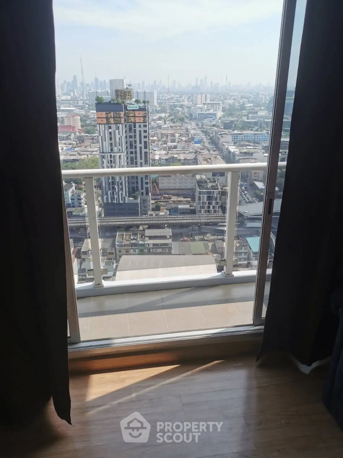 Stunning cityscape view from a high-rise balcony, perfect for urban living enthusiasts.