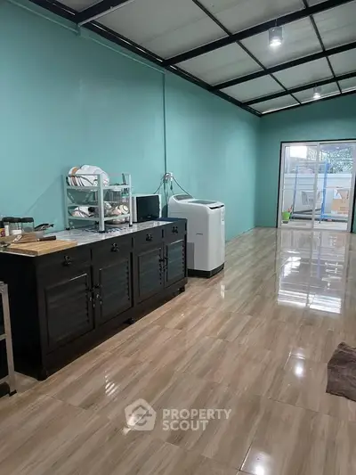 Spacious kitchen with modern appliances and sleek cabinetry in a bright, airy room.