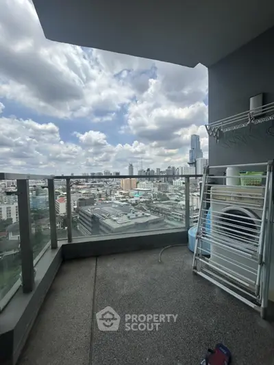 Stunning city view from a high-rise balcony with laundry area.