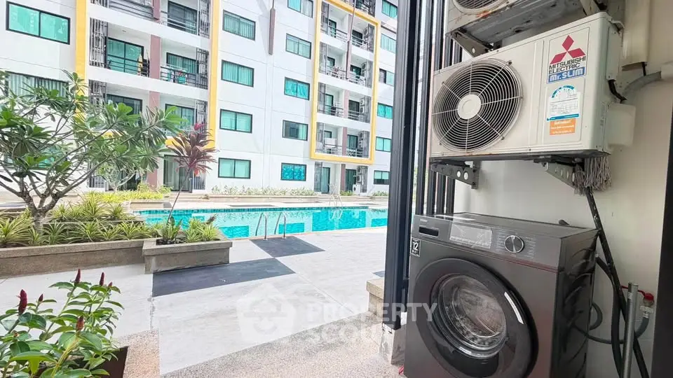 Modern apartment complex with pool view and laundry appliances, ideal for urban living.