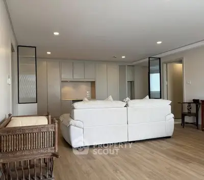 Spacious modern living room with elegant decor and cozy seating area, perfect for relaxation and entertainment.