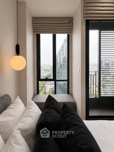 Modern bedroom with city view and balcony access in luxury apartment