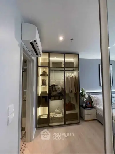 Modern bedroom with stylish glass wardrobe and cozy seating area