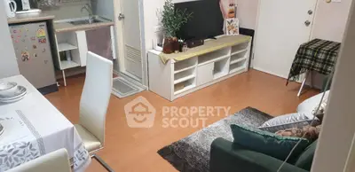 Cozy living room with modern decor and open kitchen layout, perfect for urban living.