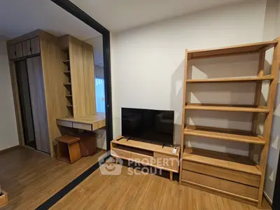 Modern living room with wooden furniture and built-in storage solutions.