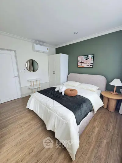Modern bedroom with stylish decor and cozy ambiance, featuring a plush bed and elegant furnishings.