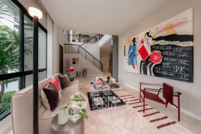 Luxurious modern living room with stylish decor and large artwork, featuring floor-to-ceiling windows and elegant furniture.