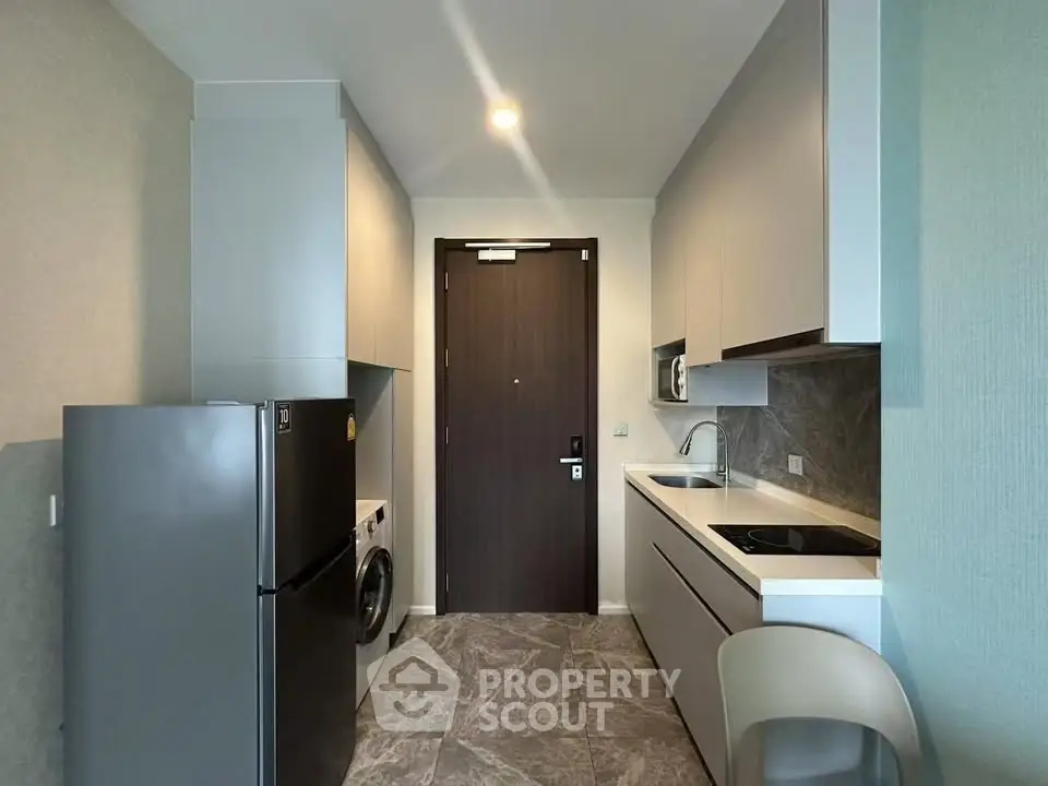 Modern compact kitchen with sleek appliances and stylish cabinetry