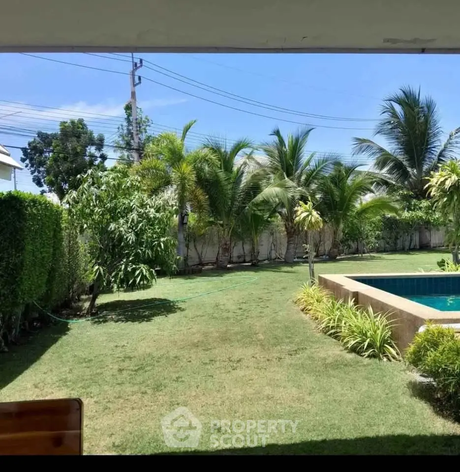 Lush garden with a private pool and tropical landscaping, perfect for relaxation and outdoor activities.
