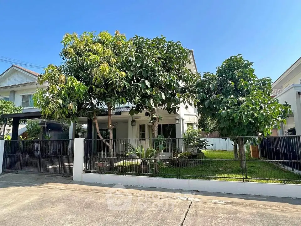 Charming suburban house with lush garden and spacious front yard, perfect for family living.
